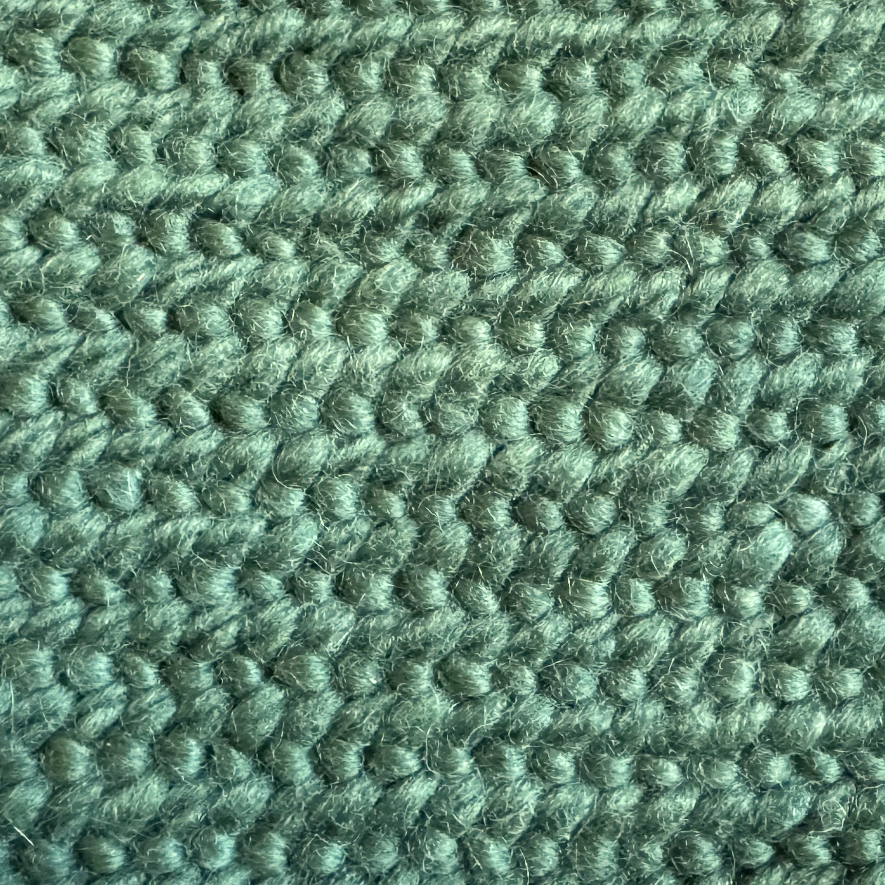 A swatch of Oslo stitch, done in ivy-green wool yarn